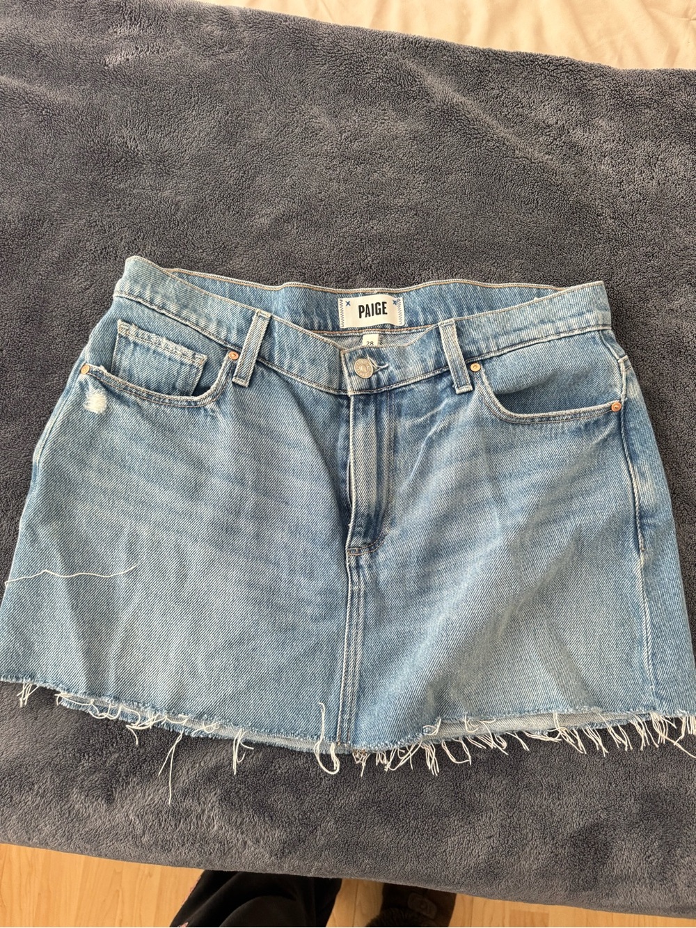 PAIGE Light Wash Denim Mini Skirt with Frayed Hem